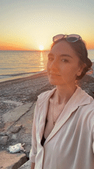 Woman takes sunset selfies at beach, railway in Sochi