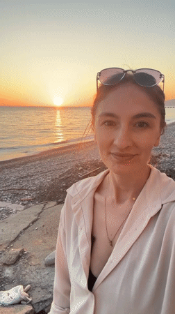 Woman takes sunset selfies at beach, railway in Sochi