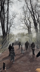 Families play in Peterhof fountain sprays on spring day