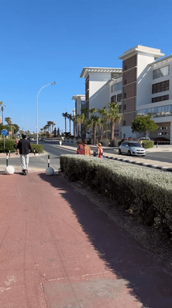 Sunny afternoon stroll through palm-lined Paphos streetscape