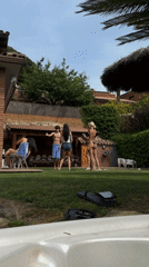 Backyard gathering with hot tub documented in Spanish coastal town