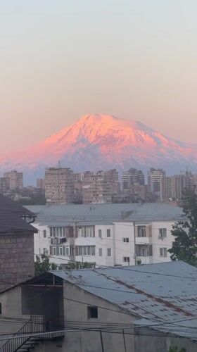 Mount Ararat displays pink-hued snow cap over Yerevan cityscape
