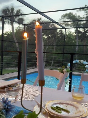 Evening dinner party held at poolside patio in Naples
