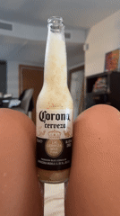 Cold Corona with a foamy head, Ibiza indoor setting.