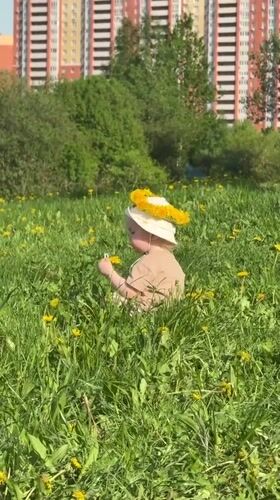 Mother and child enjoy dandelion crown picnic in Vladimir