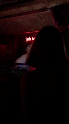 DJ performs at Belgrade nightclub under neon signs
