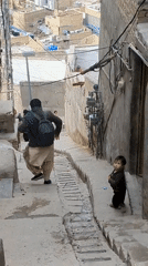 Hikers Navigate Rocky Paths Above Quetta Under Overcast Skies