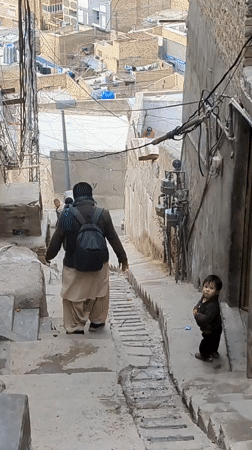 Hikers Navigate Rocky Paths Above Quetta Under Overcast Skies