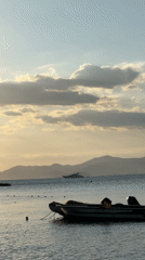 Child plays on Turkish beach during golden sunset hour