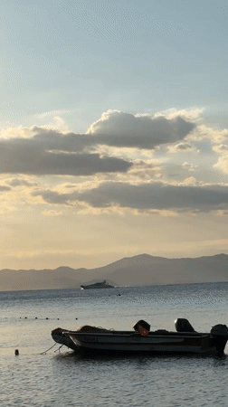 Child plays on Turkish beach during golden sunset hour