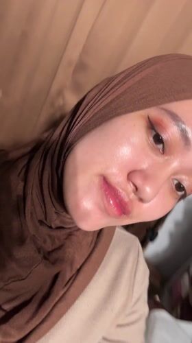 Young woman takes selfies in Indonesian towns Tuesday afternoon