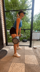Morning barbell workout session on outdoor patio in Baranovka