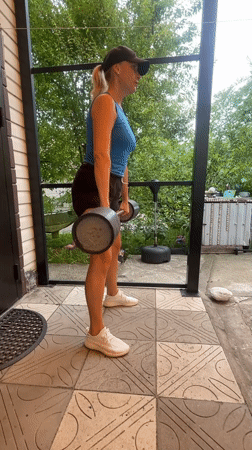 Morning barbell workout session on outdoor patio in Baranovka