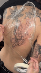 Fresh winged tattoo receives protective wrapping in Buenos Aires