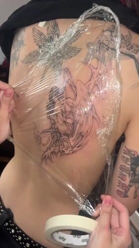 Fresh winged tattoo receives protective wrapping in Buenos Aires
