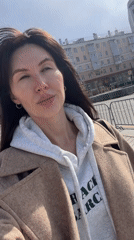Woman films selfie video on sunny Perm street