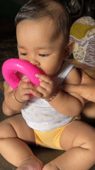 Two babies, a pink ring toy, and a calm moment in Kruengmate