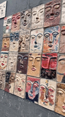 Ceramic face tile wall art documented in Yerevan