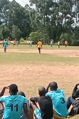 Soccer teams in blue and yellow play match