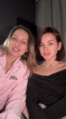 Two women share drinks and pose in Лобаново, Russia