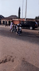 Children and teens walk through residential streets during morning hours