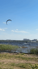 Kitesurfers practice on sunny afternoon waters near Izhevsk, Russia