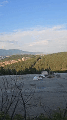 Aerial view captures Sliven cityscape between mountains, construction visible