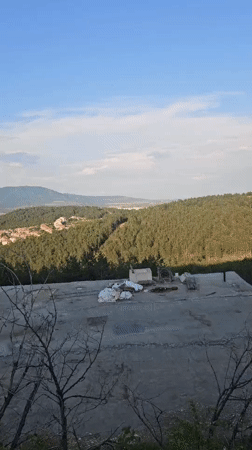 Aerial view captures Sliven cityscape between mountains, construction visible