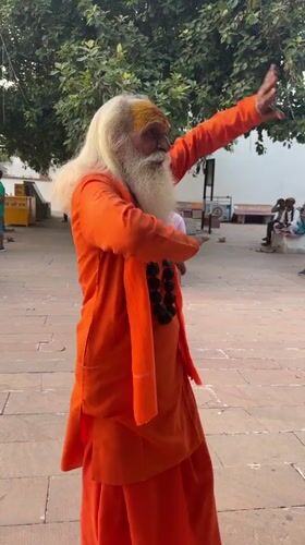 Sadhu at Pushkar Lake ghats during a warm July sunset