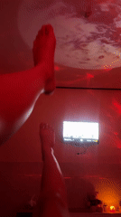 Red-lit room with planetary projector, tropical garden under moonlight