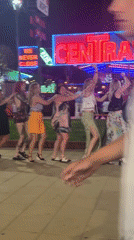 Six women form conga line dancing in Nesebar evening