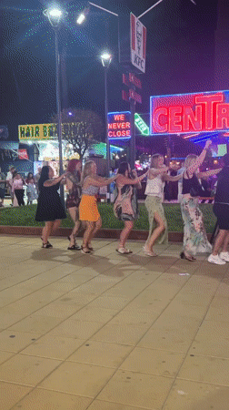 Six women form conga line dancing in Nesebar evening