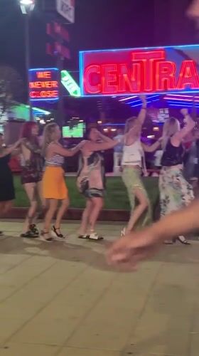 Six women form conga line dancing in Nesebar evening