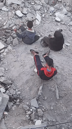 Children play amid rubble in Khan Yunis streets