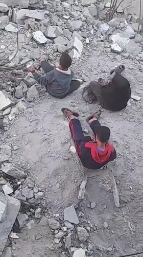 Children play amid rubble in Khan Yunis streets