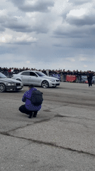 Crowd films SUV drag race preparation in Ostrovo Bulgaria