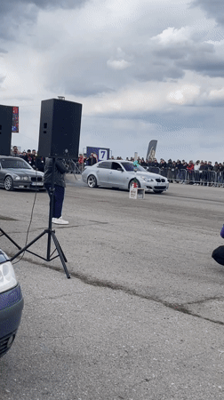 Crowd films SUV drag race preparation in Ostrovo Bulgaria