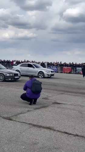 Crowd films SUV drag race preparation in Ostrovo Bulgaria