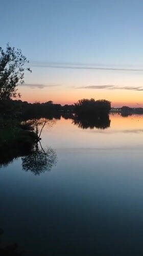 Bronnitsy at golden hour: pond, park, and church at dusk
