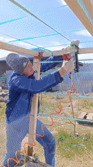 Construction worker builds wooden frame in Chaikovsky, Russia