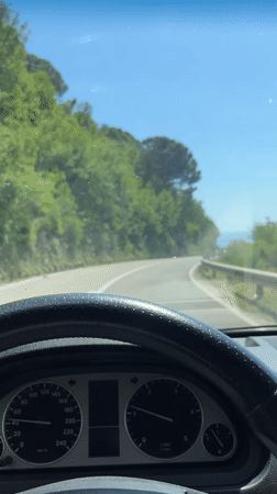 Driver navigates winding mountain road in Montenegro countryside