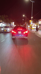 Mercedes sedan drives through Mũi Né street at night