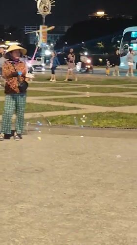 Night out at a Da Lat plaza: scooters, bubbles, and poodles