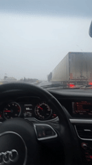 Driver navigates highway in rainy, low-visibility conditions
