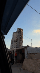 Severe structural damage to a multi-story building in Gaza