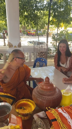 Buddhist monk blesses family at Thai temple ceremony