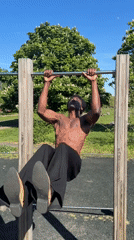 Man exercises on outdoor fitness equipment in London park