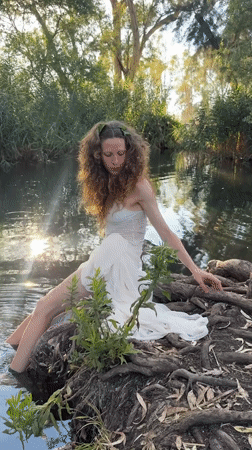 Lakeside afternoon in Katzrin: roots, white dress, resting dog