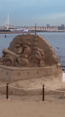 Sand sculpture exhibition lines Saint Petersburg's waterfront at dusk