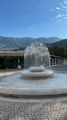 Tourist photographs fountain plaza in Budva, Montenegro